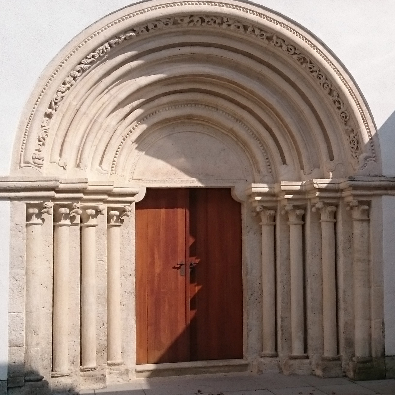 A photo of an arched door in the style of Romanesque architecture